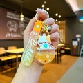 Detail of cute cat liquid keychain with orange flowing glitter and gold bell charm - Orange Kitten