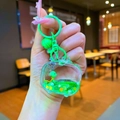 Dettaglio di un portachiavi a tartaruga in acrilico con sabbia mobile e forma di TV retro - Stile Chiusura a Moschettone / Televisore Hardware Verde Tartaruga