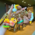 Cute Capybara keychain collection with funny burger and popcorn outfits held by hand - Goose Series Capybara Assorted