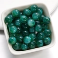Macro shot of 12mm emerald mermaid resin beads with glitter powder for DIY jewelry - Dark Green / 8mm