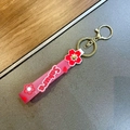 Pink semi-transparent silicone Sakura keychain with golden metal clasp and cherry blossom print - Red