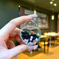 Close-up of a heart-shaped quicksand keychain with black beads and colorful tiny flowers - Without Keychain (1 Piece) / Black Luminous Bubble Bead Heart Lock