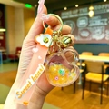 Detailed view of orange heart shaker keychain with Sweet Heart strap and gold bell - Sweet Heart Strap Luminous Beads Heart Lock / Orange