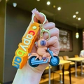 Cute Capybara riding a blue motorcycle keychain with an orange silicone hand strap - Driving Capybara Motorcycle