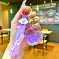Close-up of a purple heart keychain featuring liquid glitter, stars, and a soft wrist strap - Sweet Heart Strap Luminous Beads Heart Lock / Purple