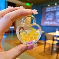 Close-up of heart-shaped keychain with yellow glitter balls and colorful flowers inside - Without Keychain (1 Piece) / Orange Luminous Bubble Bead Heart Lock
