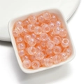 Nahaufnahme von lichtdurchlässigen pfirsichfarbenen Acrylperlen mit großen Löchern für DIY - 50 Stück/Packung (6x9mm) / Meerjungfrau Orange