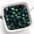 Detailed view of dark green cat eye resin beads with 1.5mm holes for DIY jewelry - 8mm / Dark Green