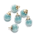 Detailed view of six light blue bead-filled glass charms with gold metal caps for DIY jewelry - 5 Pcs/Pack / Round Light Blue