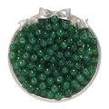 Macro detail of dark green apple-shaped glass beads for jewelry making in silver dish - Dark Green