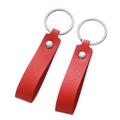 Macro detail of red faux leather keychain loops with silver rivets and metal rings - Red Lychee Fold