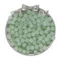 Close-up of translucent mint green glass apple beads in a decorative silver tray for DIY - Light Green