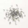 Macro shot of silver clamshell bead tips for DIY jewelry making on white background - White Gold