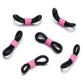 Macro detail of 8-shaped non-slip silicone eyeglass chain connectors with pink metal coils - 50 Pieces / Black-Pink (AC3135)