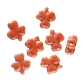 Macro detail of orange clover ceramic beads for DIY jewelry making with side drill holes - Orange