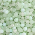 Close-up of mixed light green crackle glass beads in various shapes for DIY jewelry making - 20.00g / Green Series