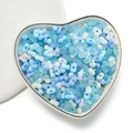 Macro detail of mixed blue 4mm acrylic peanut beads in a heart-shaped ceramic dish - 100 Units (3x4x6.5mm) / Transparent Blue Mix