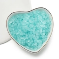 Detailed view of mint blue dumbbell-shaped acrylic beads in a heart porcelain dish - 100 Units (3x4x6.5mm) / Transparent Light Blue