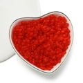 Macro shot of 4mm red translucent peanut beads in a heart dish for DIY jewelry making - Matte Red