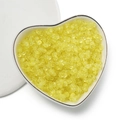 Macro shot of 4mm translucent yellow peanut beads in a heart-shaped ceramic dish - Matte Yellow