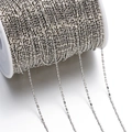 Macro shot of 1.5mm metal bead chain on a white spool for DIY jewelry making - 5m Pack (1.5mm) / White K/Silver