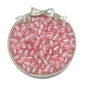Macro shot of 10mm pink and white striped resin beads with fine glitter in silver tray - Pink