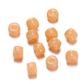 Macro detail of translucent pale pink cylindrical glass beads for DIY jewelry making - 1 String (Approx. 60 Pcs, 6x8.5mm) / Jelly Orange