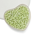 Dettaglio di perle acriliche irregolari verde chiaro perlescenti in un vassoio a cuore - 100 Pezzi/Confezione / Perla Artificiale-Verde