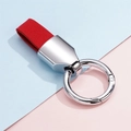 Detail of red suede leather strap and polished silver metal ring keychain on pastel backdrop - 1 Piece / Silver Red
