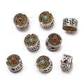 Macro shot of Tibetan style alloy beads with silver and gold finish and cloud patterns - 1pc/pack / Style 11 (Tibetan Meander Bead)