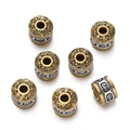 Macro shot of Tibetan style gold and silver cylinder beads with embossed patterns - 1pc/pack / Style 13 (Religious Mantra Bead)