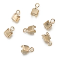 Detail of seven gold-plated metal crimp ends with rings for DIY jewelry making - 100pcs Pack / 3*5.5mm / KC Gold