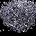 Macro shot of iridescent purple and grey crushed glass stones for DIY crafts - Gray