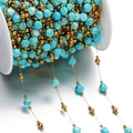 Detailed macro view of turquoise stone beads and gold beads on a white plastic spool - Gold Style 06
