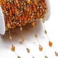 Macro shot of orange faceted gemstones and gold metal beads on a DIY jewelry chain - Gold Style 07