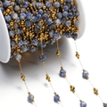 Macro shot of blue faceted natural stones and gold beads on a DIY jewelry chain roll - Gold Style 10
