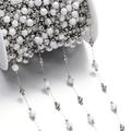 Detailed macro of white marbled stone beads on silver chain for jewelry making - Steel Style 11