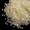 Irregular iridescent crystal stones for nail art and DIY decor on black background - Yellow