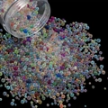 Macro shot of mixed size iridescent glass bubble beads pouring from a clear jar - 28g per Box / Mixed Random