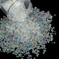 Macro shot of iridescent AB glass bubble beads pouring from a clear bottle for nail art DIY - 28g per Box / Mixed Transparent