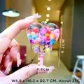 Vue détaillée des dimensions d'un porte-clés flacon en cœur avec perles arc-en-ciel - Forme Clé Cœur