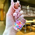 Close-up of pink lobster clasp keychain with rainbow bead drifting bottle and bell - Lobster Clasp Style / Iridescent