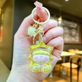 Macro shot of translucent yellow star keychain with gold ring held in hand - Gold Hardware Electroplated Star Person / Aurora Yellow