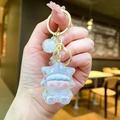 Detail of a holographic star person keychain with gold metal clasp and colorful bead - Gold Hardware Electroplated Star Person / Iridescent White
