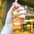 Close-up of translucent orange star keychain with glitter and golden metal ring - Gold Hardware Electroplated Star Person / Aurora Orange