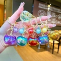Colorful translucent apple-shaped keychains in six vibrant colors with golden metal rings - Gold Hardware Multicolor Electroplated Persimmon