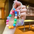 Close-up of colorful beaded keychain with LAZ letter beads and iridescent heart pendant - Multicolor Beaded (White)