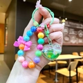 Close-up of colorful beaded heart keychain with liquid quicksand charm and bow accent - Random Bowknot Beads / Green Gradient Beads Heart