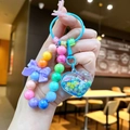 Gros plan du porte-clés en forme de cœur avec perles colorées et nœud violet - Perles de Nœud Aléatoires / Cœur Perles Bleues