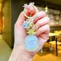 Detailed close-up of a pearlescent resin pineapple pendant with golden keyring and crystal - White (Gold Hardware)